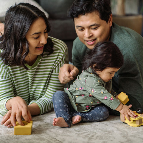 parents and child playing with blocks