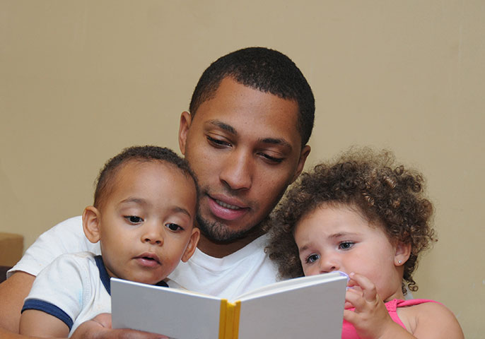 father reading to boy and girl