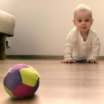 child crawling to ball