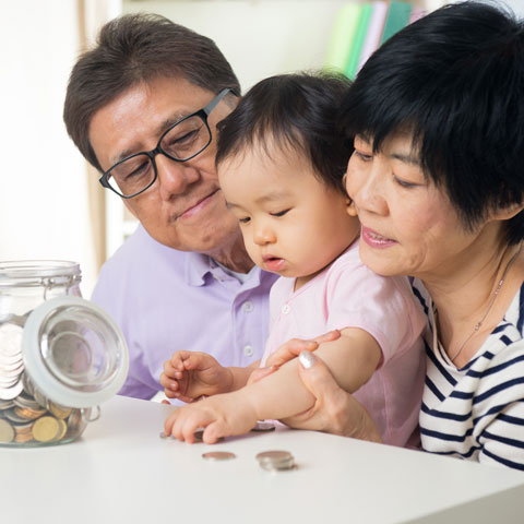 parents and child with jar of change
