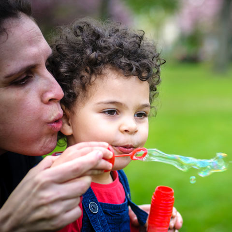mom and child blowing bubbles