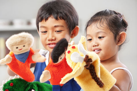 boy and girl playing with puppets