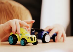 toddler hands with toy cars