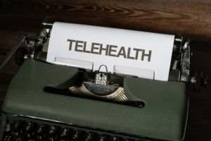 paper with telehealth typed on retro typewriter