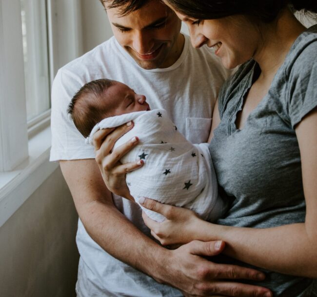 parents holding newborn